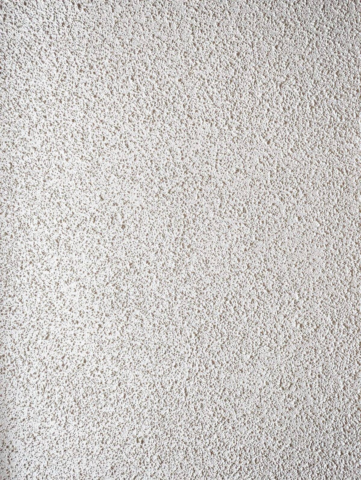 Close-up photo of white popcorn (acoustic) ceiling texture with its rough, cottage-cheese surface